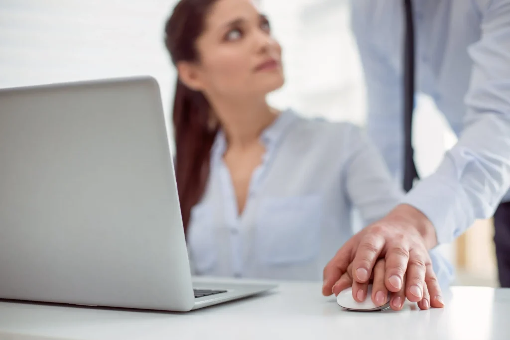 A woman sitting at her desk working on her computer when a male colleague puts his hand on hers without consent. If you've experienced sexual harassment while at work, our compassionate sexual harassment attorney in Kansas City knows how demeaning and damaging this can be.