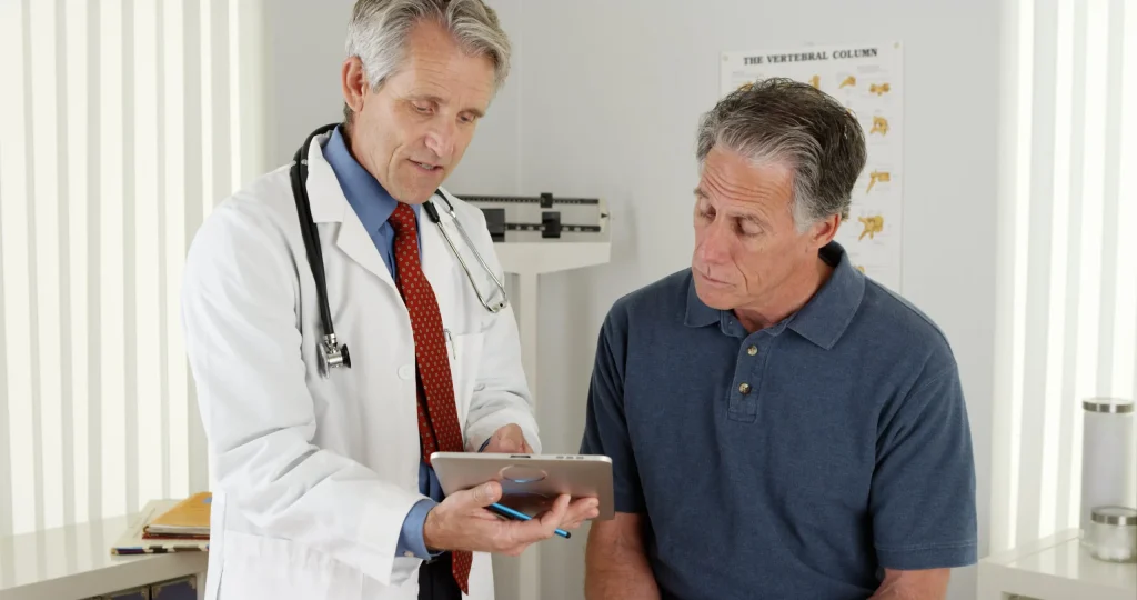 A doctor discussing with a patient the nature of their port catheter complications and that it may be beneficial to reach out to a Missouri port catheter injury lawyer to help seek compensation.