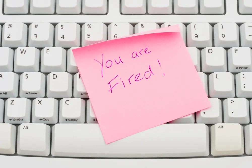You are Fired written on a pink post it note.