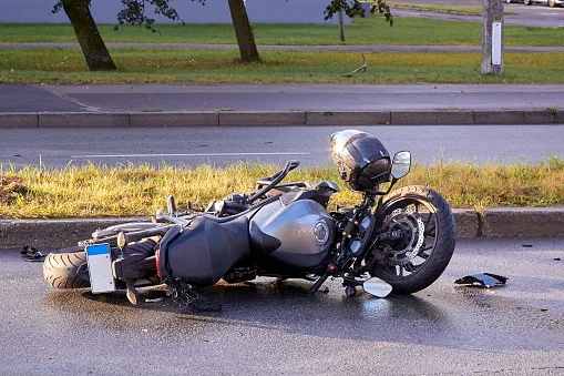 A crashed motorcycle lying on the road.