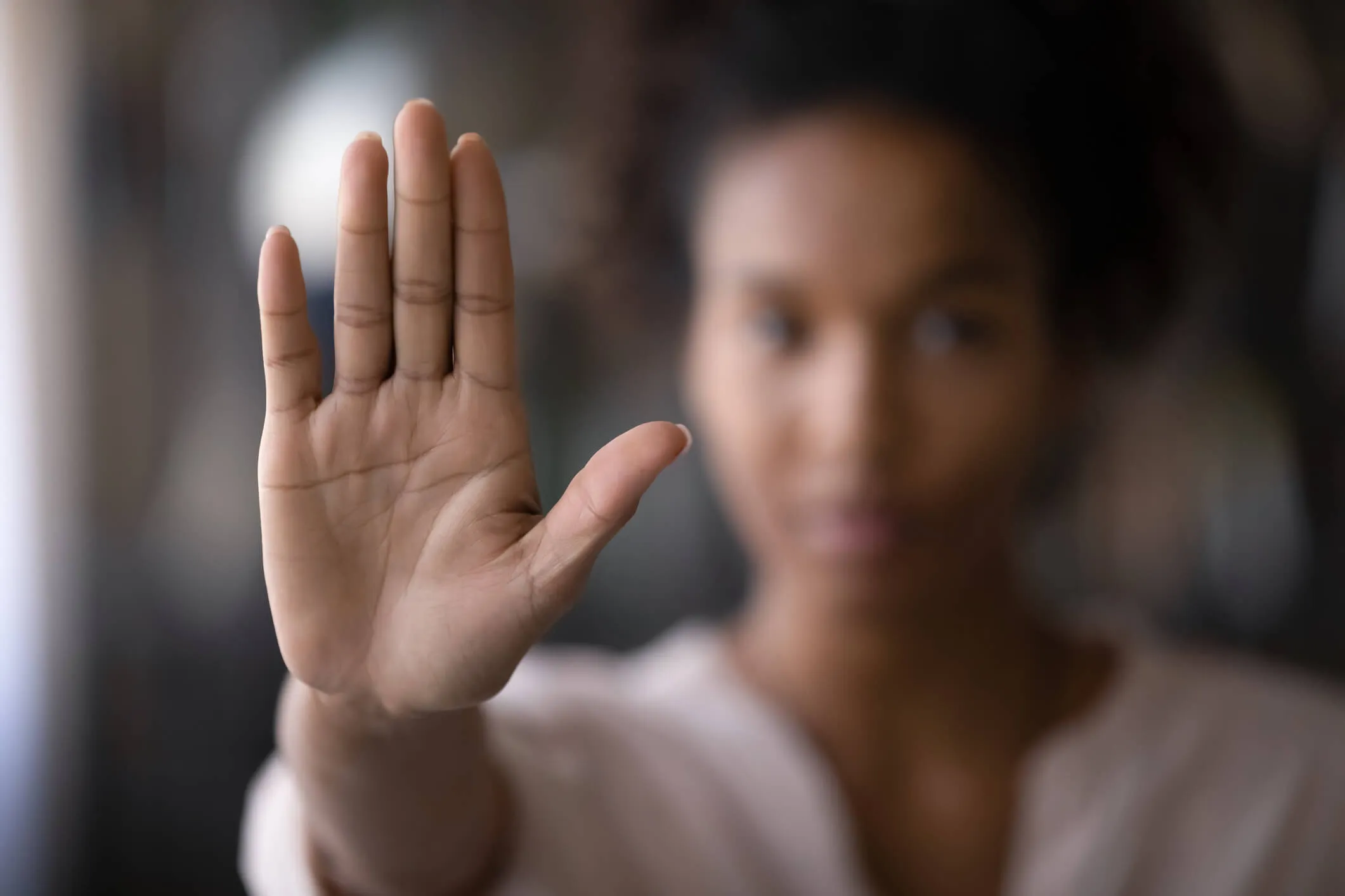 A woman holding up her hand to imply "stop".